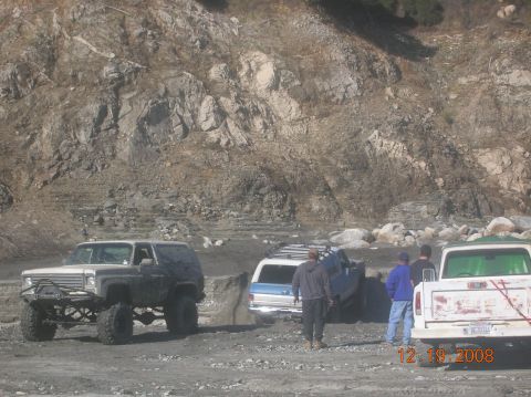 1985 Ford Bronco - Multiple off-road vehicles are gathered in a , rocky terrain, with a date stamp indicating the photo was taken on December 19, 2008.