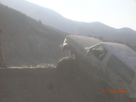 1985 Ford Bronco - A white SUV is stuck in mud on a hillside, with a date stamp of 12.19.2008 in the corner.