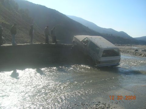 1985 Ford Bronco - A white van is stuck in a river, with several people watching from the bank. The date stamp on the photo reads 12-20-2008.