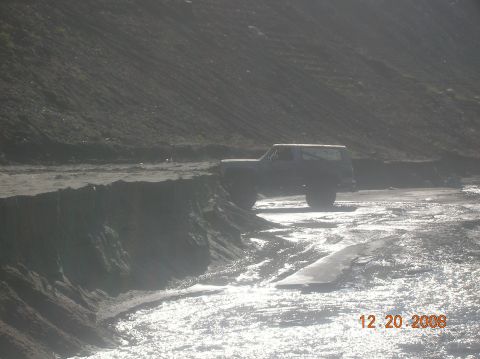 1985 Ford Bronco - This 1985 Ford Bronco is seen parked on a dirt road with a steep embankment to its left.
