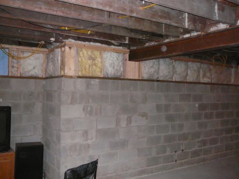 1997 Mercury Grand Marquis - The photo shows an unfinished basement with exposed joists, insulation, and concrete block walls.