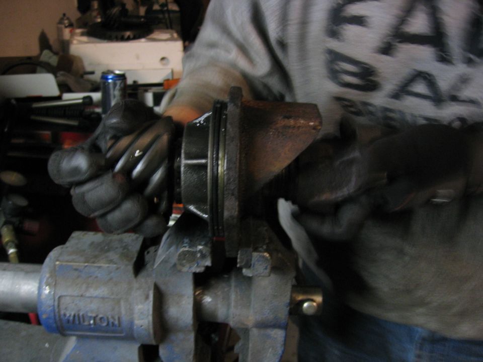 Pinion yoke assembly clamped in a bench vise being worked on