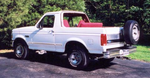 1993 Ford Bronco - White 1992 Ford Bronco with red interior and spare tire on the back.