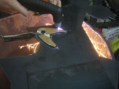 1990 Ford Bronco - Photograph of plasma cutting a steel panel, not a technical document.