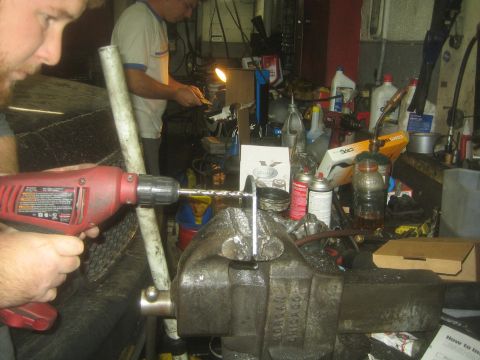 1990 Ford Bronco - Tristan far in the back ground & David up close. Grinding & drilling the mounting brackets.