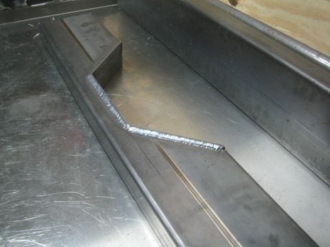 1990 Ford Bronco - Photograph of a welded fabricated steel bar, not a technical document.
