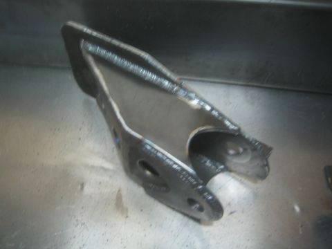1990 Ford Bronco - Photograph of a fabricated welded steel suspension bracket, not a technical document.