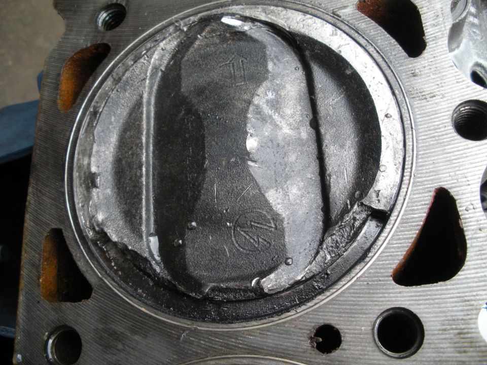 Damaged piston in an engine cylinder