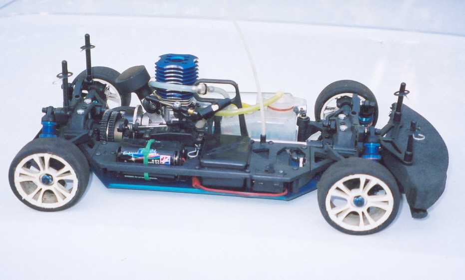 Radio controlled car chassis with blue engine and white wheels