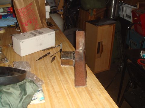 1992 Ford Bronco - A workbench scene with tools and a white box is shown. A metal bracket is welded and standing upright on the table.
