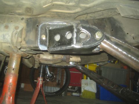1990 Ford Bronco - Photograph of a fabricated suspension mount installed on a vehicle underbody, not a technical document.