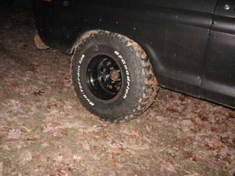 1978 Ford Bronco - A BFGoodrich Mud-Terrain tire is mounted on a black vehicle, seen from the side.