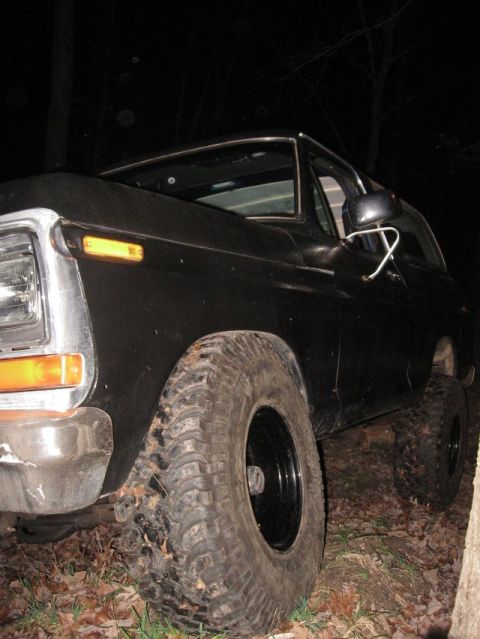 1978 Ford Bronco - A black 1978 Ford Bronco is shown from a low front three-quarter angle at night.