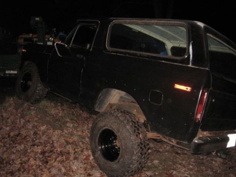 1978 Ford Bronco - This black 1978 Ford Bronco is shown off-road with large tires and a lifted suspension.