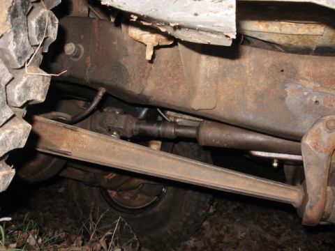 1978 Ford Bronco - Close-up of vehicle undercarriage, focusing on mechanical parts and suspension.