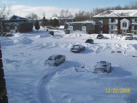 1995 Mercury Grand Marquis - Cars are stuck in a snow-covered parking lot after a winter storm.