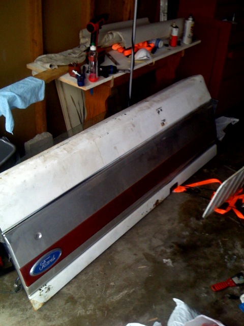 1987 Ford Bronco - Ford tailgate with blue oval emblem and red stripe, appears to be from an older model.