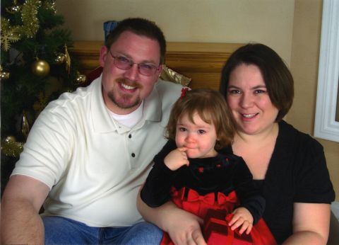 2000 Ford Crown Victoria - A family poses for a holiday photo in front of a Christmas tree.