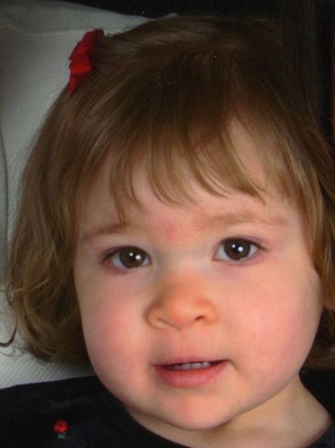 2000 Ford Crown Victoria - A young child with a red bow in her hair looks towards the camera.