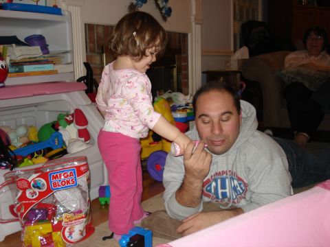 2000 Ford Crown Victoria - A father lies on the floor while his young daughter plays with a toy.