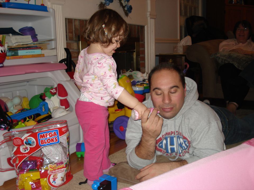 Child playing with father indoors