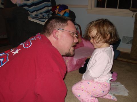 2000 Ford Crown Victoria - A man and a young child are engaged in conversation while sitting on the floor.