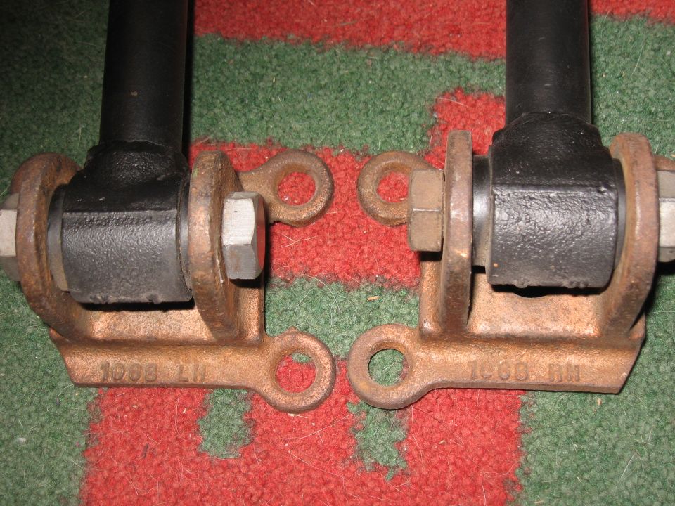 Two rusty metal suspension parts labeled 1008 LH and 1008 RH.