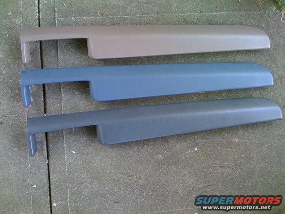 Three automotive interior trim pieces in tan, blue, and dark gray.
