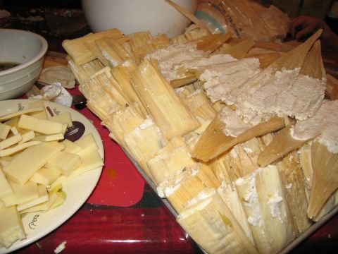 1986 Ford Bronco - A close-up shot shows a large quantity of tamales being prepared, with some wrapped in corn husks and others filled with a white creamy mix…