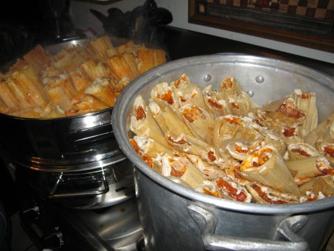 1986 Ford Bronco - Two large pots filled with tamales are steaming on a stovetop.