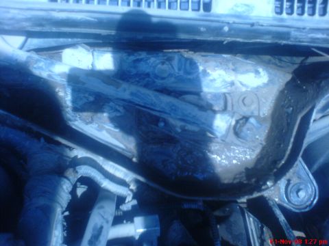 1992 Ford Crown Victoria - This image shows a close-up view of the engine bay of a Ford Crown Victoria, focusing on the area around the windshield wipers. Mud and deb…