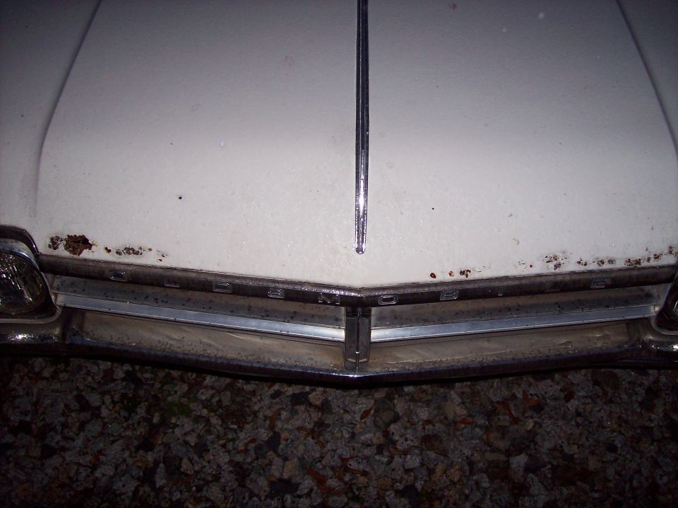 1966 Oldsmobile Cutlass front view with chrome grille and rust spots