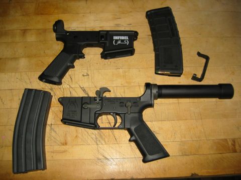 1996 Ford Bronco - The image shows disassembled parts of an AR-15 style rifle laid out on a wooden surface. Visible components include two lower receivers, tw…