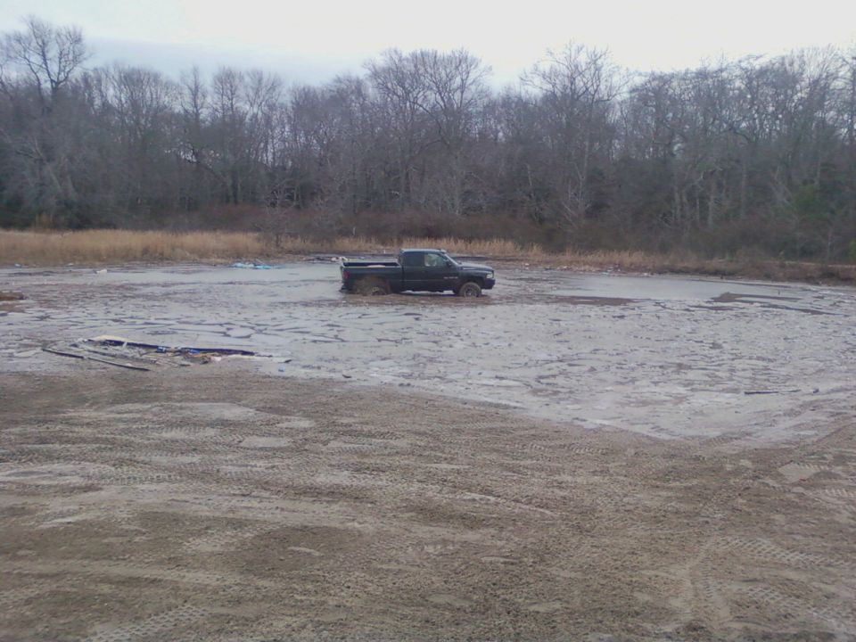 Black Ford F-150 stuck in mud