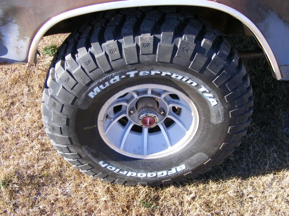BFGoodrich Mud-Terrain T/A tire on a vintage vehicle wheel, close-up.