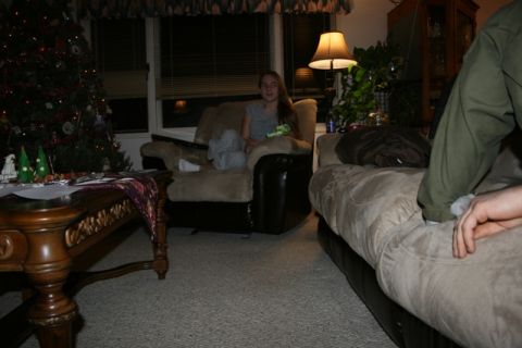 1990 Chevrolet Suburban - A young woman sits in a recliner in a dimly lit living room with a Christmas tree visible on the left.