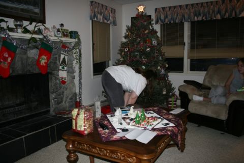 1990 Chevrolet Suburban - A living room decorated for Christmas with a tree and stockings hung by the fireplace. A person is bending over a coffee table in front of…