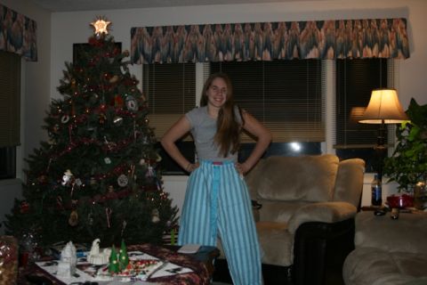 1990 Chevrolet Suburban - A young woman stands in front of a decorated Christmas tree wearing striped pajama pants.