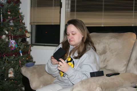 1990 Chevrolet Suburban - A woman sits on a couch next to a decorated Christmas tree, looking disappointed as she holds a small black box.