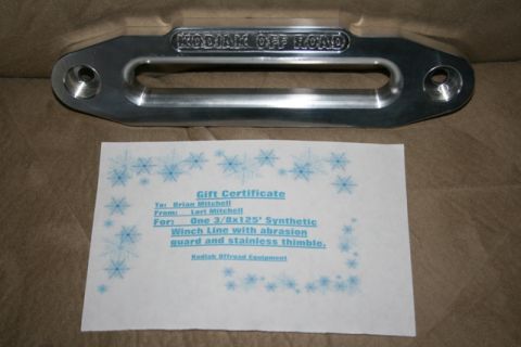 1990 Chevrolet Suburban - A silver "Kodiak Off Road" winch shackle mount is displayed above a gift certificate for a synthetic winch line. The gift certificate is fo…