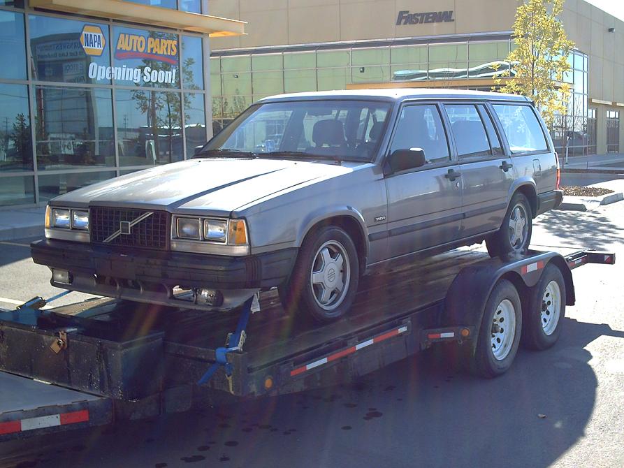 Silver Volvo 740 wagon on a flatbed trailer