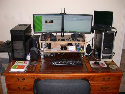 2000 Ford Crown Victoria - A cluttered desk with two computer monitors, two desktop computer towers, a keyboard, a mouse, and various other electronic devices and off…