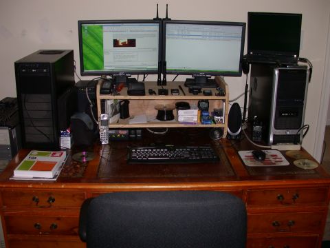 2000 Ford Crown Victoria - A cluttered computer desk with two monitors, two computer towers, a keyboard, a mouse, and various electronic accessories.