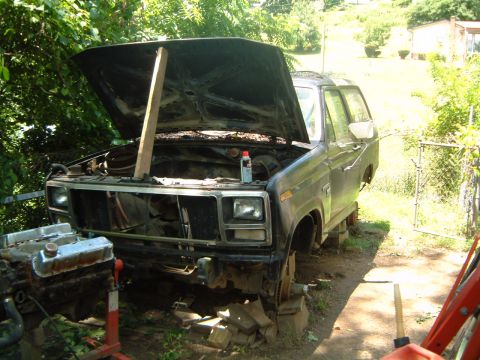 1982 Ford Bronco - This 1980s Ford Bronco is shown with its hood open and the front end partially disassembled, suggesting it is undergoing repairs or restora…