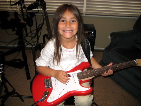 1996 Ford Bronco - A young girl is ready to rock out on her red electric guitar.