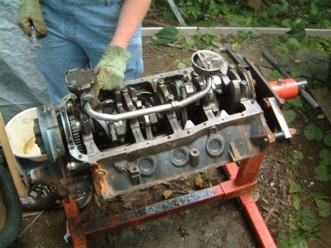 1982 Ford Bronco - An engine block is being worked on, with the crankshaft and connecting rods exposed.
