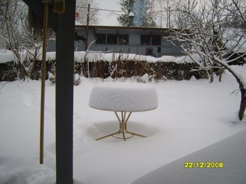 1989 Ford Bronco - A snowy scene shows a table and yard covered in winter's blanket.