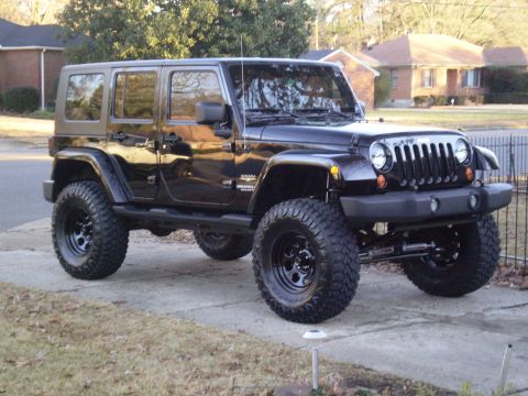 1997 Jeep Wrangler - This Jeep Wrangler features a distinctive grille and body style, indicating a later model year.