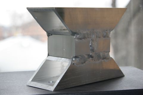 1992 Ford Taurus - This aluminum H brace features prominent welds and a unique shape, suggesting it is a custom or aftermarket automotive part.