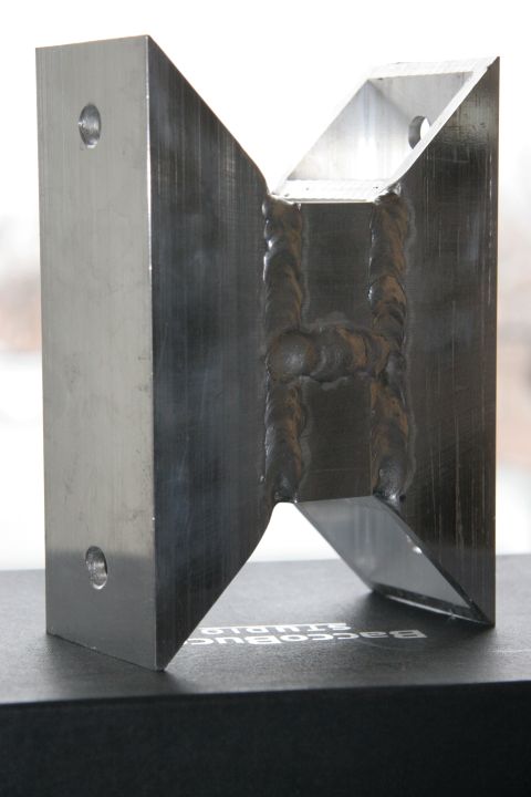 1992 Ford Taurus - This is a custom aluminum H brace part, showing visible welding marks and mounting holes.